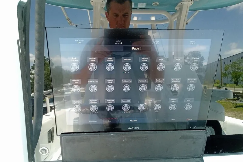 Slide: The Image of 2022 Sportsman Open 302 Center Console touchscreen display with various control options. - 27