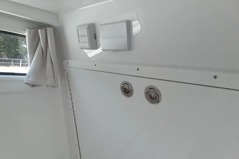 Slide: The Image of Interior of 2022 Sportsman Open 302 Center Console boat with storage compartments. - 30