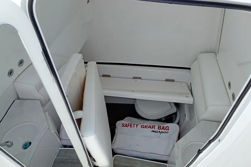 Slide: The Image of 2022 Sportsman Open 302 Center Console interior with safety gear bag and seating. - 31