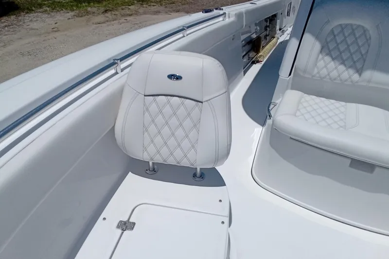 Slide: The Image of 2022 Sportsman Open 302 Center Console boat with white cushioned seating and diamond stitching. - 35