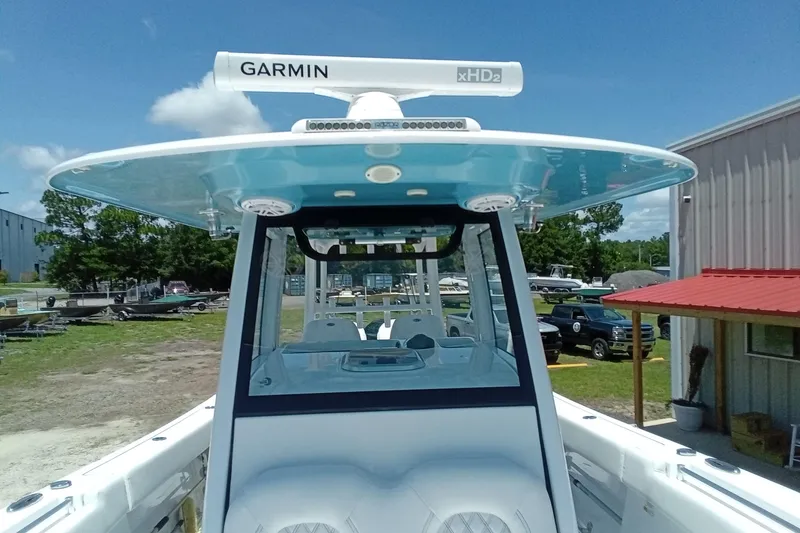 Slide: The Image of 2022 Sportsman Open 302 Center Console boat with Garmin xHD2 radar, docked outdoors. - 37