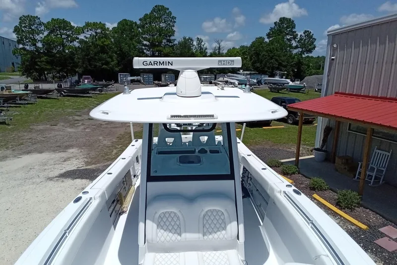Slide: The Image of 2022 Sportsman Open 302 Center Console boat with Garmin radar, parked outdoors. - 39