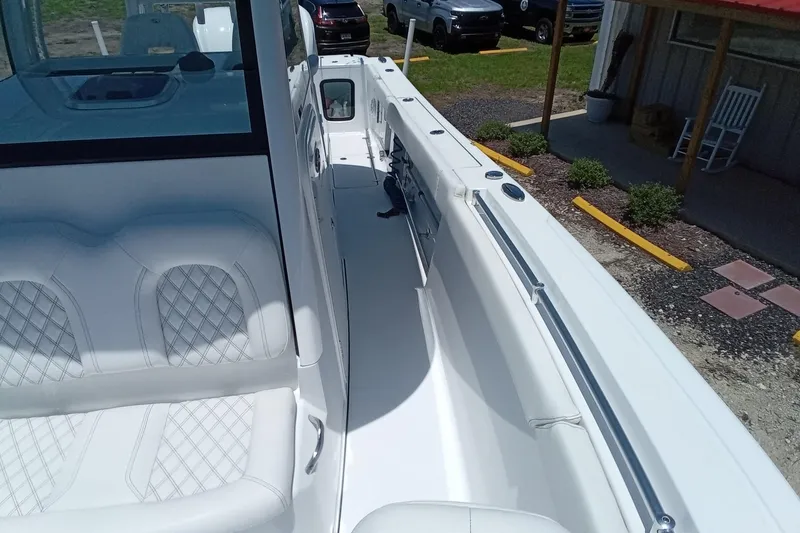 Slide: The Image of 2022 Sportsman Open 302 Center Console boat with white seating and sleek design. - 40