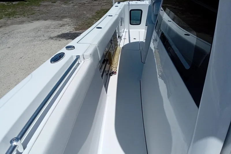 Slide: The Image of 2022 Sportsman Open 302 Center Console boat deck, featuring sleek white design and modern fittings. - 41
