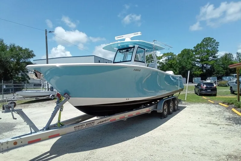 Slide: The Image of 2022 Sportsman Open 302 Center Console boat on trailer, parked outdoors. - 5