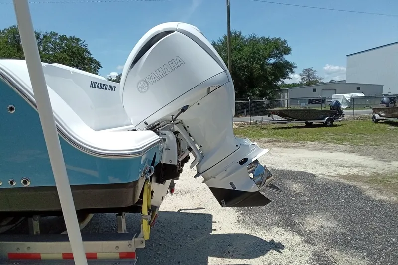 Slide: The Image of 2022 Sportsman Open 302 Center Console with Yamaha outboard motor in a boatyard. - 7