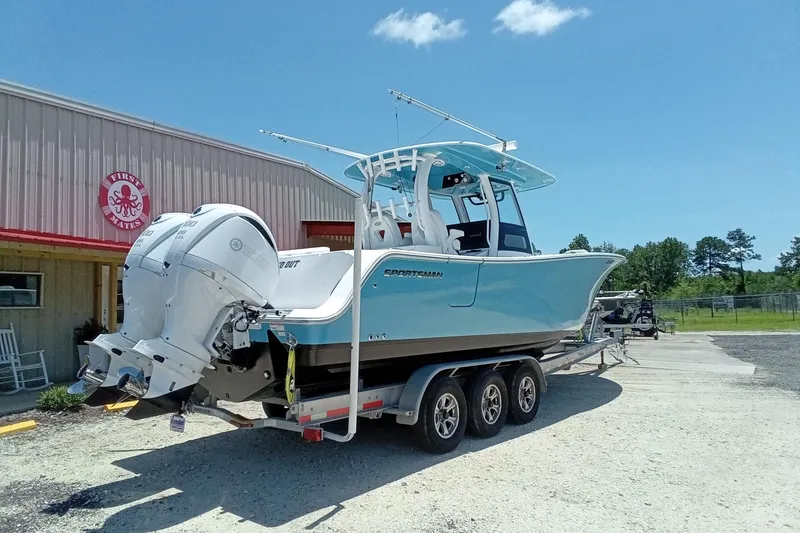 Slide: The Image of 2022 Sportsman Open 302 Center Console boat on trailer, parked outside a building. - 9
