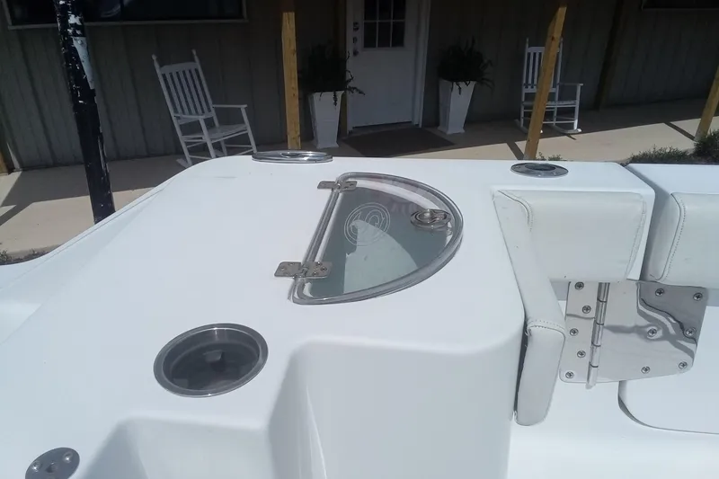 Slide: The Image of 2020 Sportsman Open 282TE Center Console boat interior with seating and cup holders. - 13