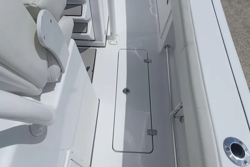 Slide: The Image of 2020 Sportsman Open 282TE Center Console interior with seating and storage compartment. - 14