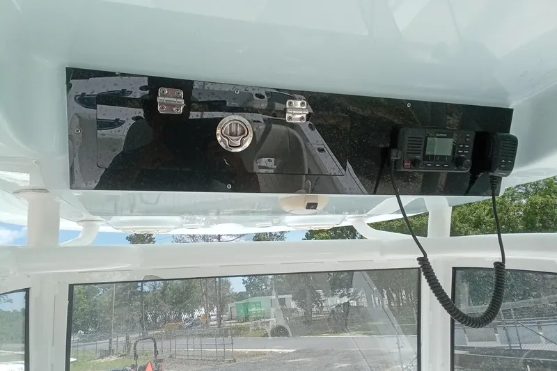 Slide: The Image of 2020 Sportsman Open 282TE Center Console boat dashboard with radio and controls. - 18