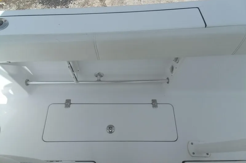 Slide: The Image of 2020 Sportsman Open 282TE Center Console boat interior, featuring storage compartment and seating. - 19