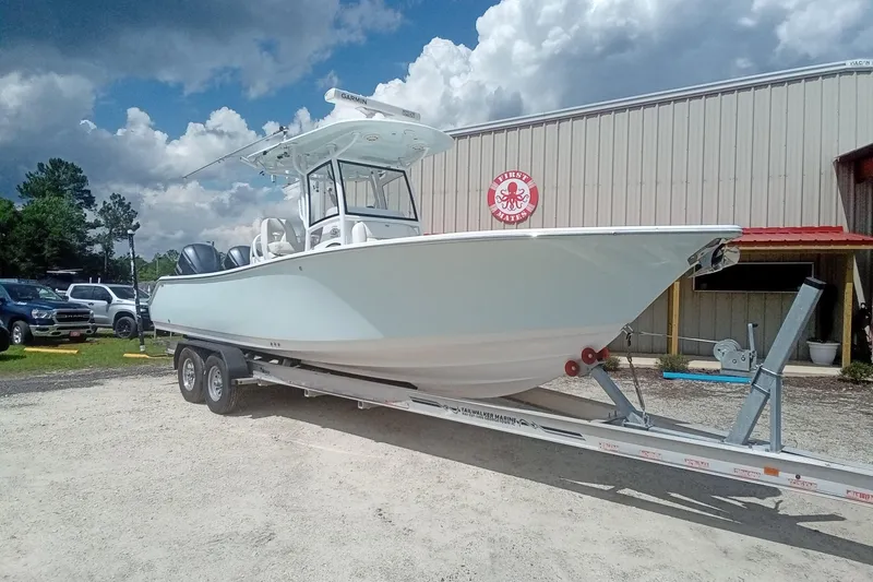 Slide: The Image of 2020 Sportsman Open 282TE Center Console boat on trailer, parked outdoors. - 2