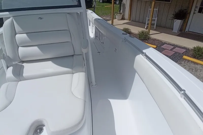 Slide: The Image of 2020 Sportsman Open 282TE Center Console boat with white seating and sleek design. - 28