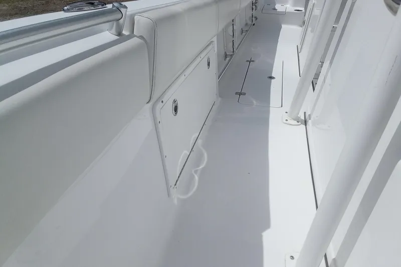 Slide: The Image of 2020 Sportsman Open 282TE Center Console boat interior, featuring sleek white deck design. - 29