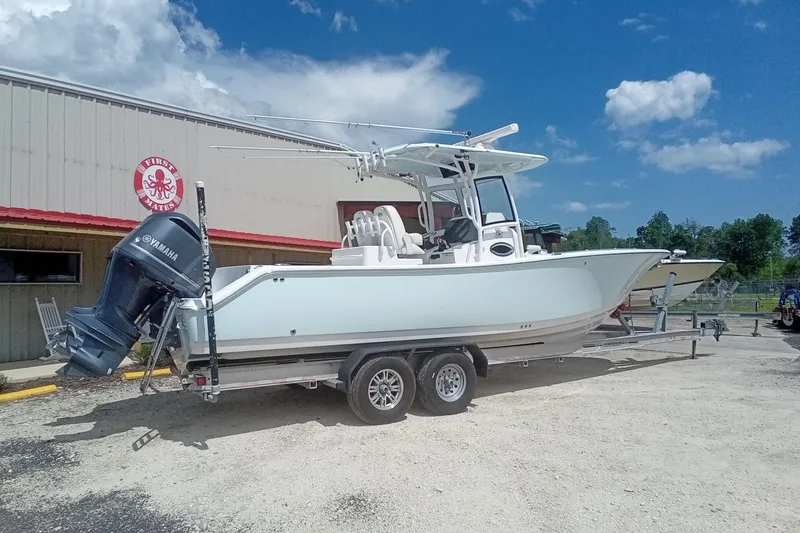 Slide: The Image of 2020 Sportsman Open 282TE Center Console boat on trailer, parked outdoors. - 3