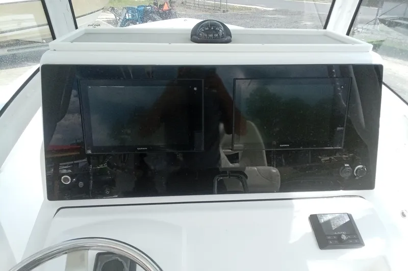 Slide: The Image of 2020 Sportsman Open 282TE Center Console dashboard with dual Garmin displays. - 30