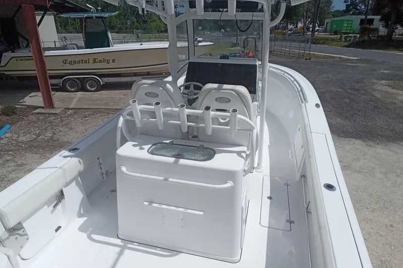 Slide: The Image of 2020 Sportsman Open 282TE Center Console boat, white interior, docked outdoors. - 6