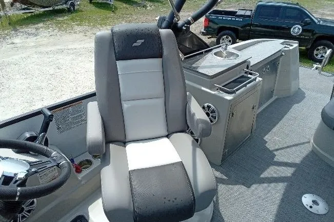 Slide: The Image of Captain's chair on 2019 Starcraft MX 23 C boat, featuring sleek design and modern controls. - 10