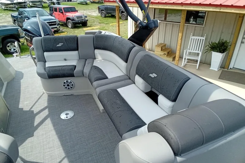Slide: The Image of 2019 Starcraft MX 23 C boat interior with gray seating and outdoor setting. - 12