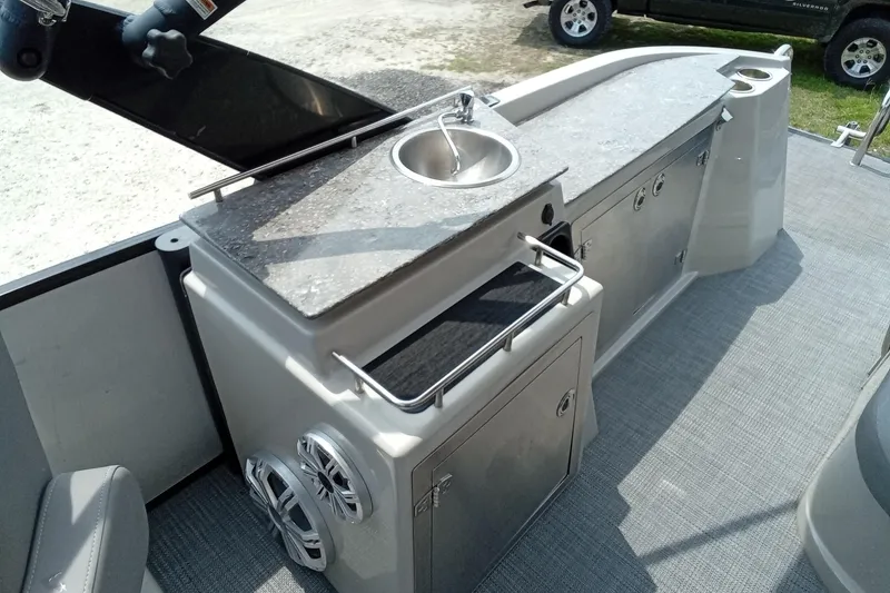 Slide: The Image of 2019 Starcraft MX 23 C boat interior with sink and storage cabinets. - 17