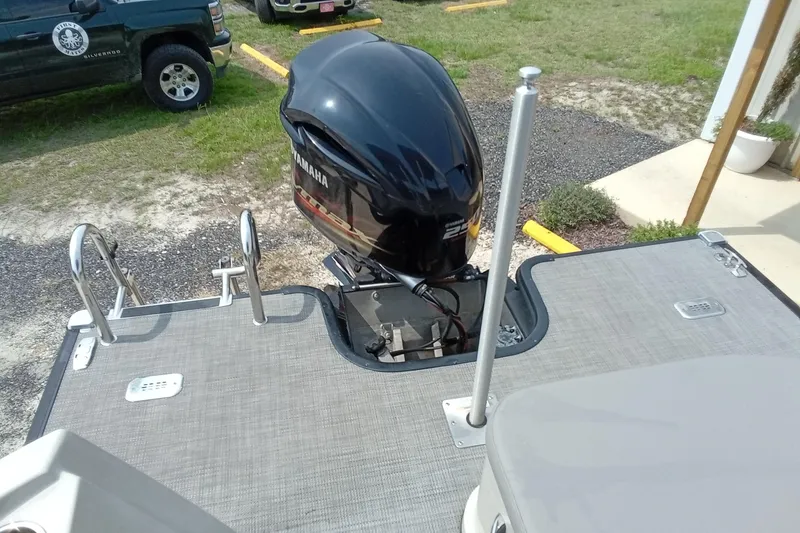 Slide: The Image of 2019 Starcraft MX 23 C boat with Yamaha outboard motor, parked near vehicles. - 20