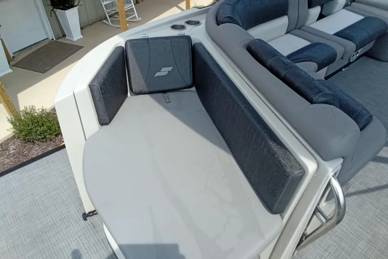 Slide: The Image of 2019 Starcraft MX 23 C boat interior with cushioned seating and cup holders. - 21