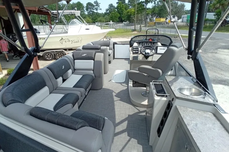 Slide: The Image of 2019 Starcraft MX 23 C boat interior with plush seating and modern helm. - 22
