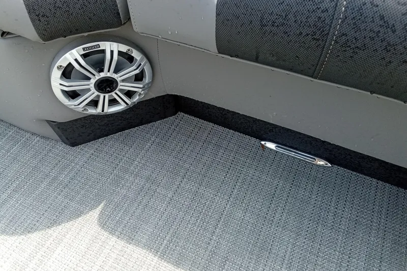 Slide: The Image of Interior of 2019 Starcraft MX 23 C boat with speaker and textured flooring. - 23