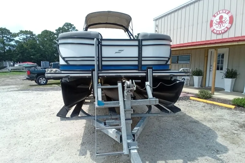 Slide: The Image of 2019 Starcraft MX 23 C pontoon boat on trailer outside a building. - 24