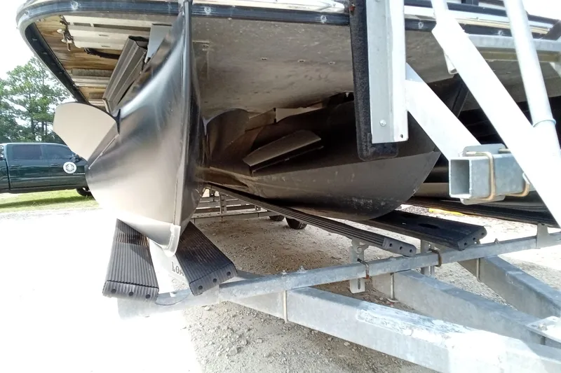 Slide: The Image of Damaged underside of a 2019 Starcraft MX 23 C boat on a trailer. - 25