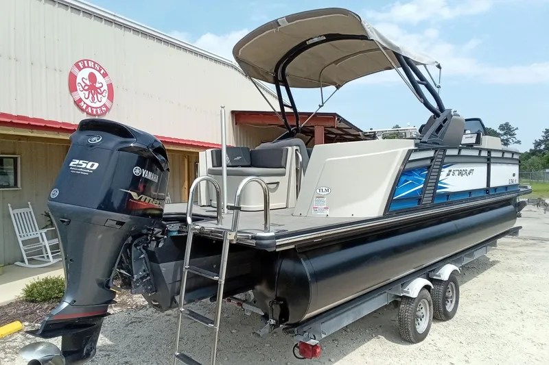 Slide: The Image of 2019 Starcraft MX 23 C pontoon boat with Yamaha 250 engine, parked on a trailer. - 31
