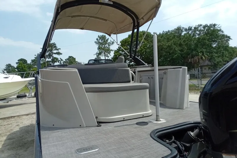 Slide: The Image of 2019 Starcraft MX 23 C pontoon boat with canopy, docked outdoors. - 32