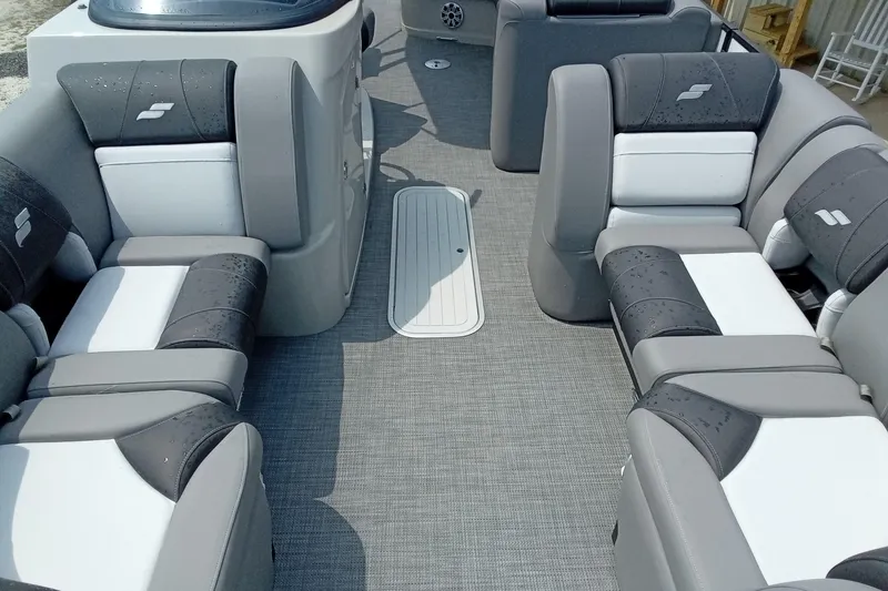 Slide: The Image of 2019 Starcraft MX 23 C boat interior with gray and white cushioned seating. - 4