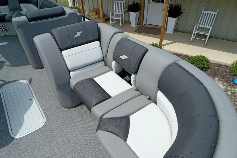 Slide: The Image of Luxurious seating on 2019 Starcraft MX 23 C boat, featuring sleek gray and white upholstery. - 6