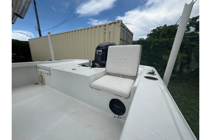 Slide: The Image of 2016 Sea Hunt BX 22 boat with Yamaha outboard motor on trailer, parked outdoors. - 2