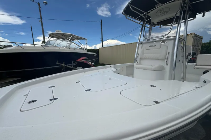 Slide: The Image of 2016 Sea Hunt BX 22 boat interior with steering wheel and Yamaha engine at sunset. - 3