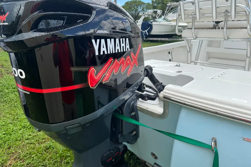 Slide: The Image of 2016 Sea Hunt BX 22 with Yamaha 200 outboard motor, docked outdoors. - 4