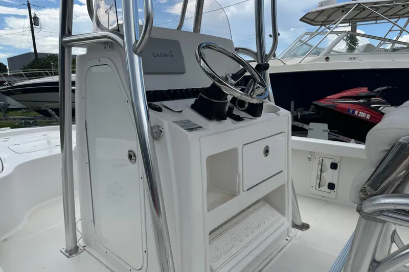 Slide: The Image of 2016 Sea Hunt BX 22 boat interior with seating and Yamaha 200 engine. - 7