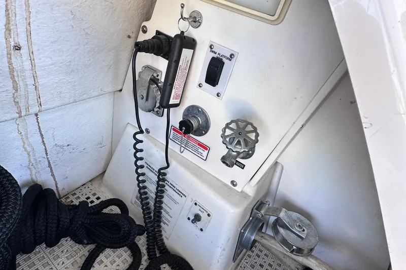 Slide: The Image of 2005 Sea Ray 48 Sundancer yacht cruising on a serene lake under a clear blue sky. - 10