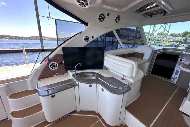 Slide: The Image of 2005 Sea Ray 48 Sundancer yacht docked under a covered marina, showcasing sleek design. - 11