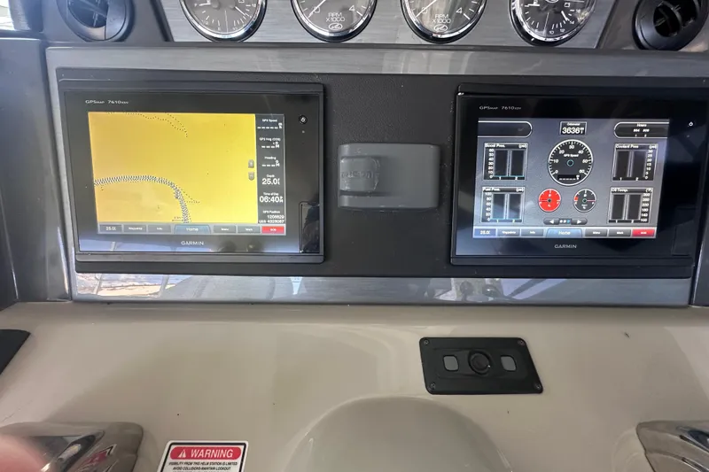 Slide: The Image of Control panel on a 2005 Sea Ray 48 Sundancer boat with coiled rope and switches. - 15