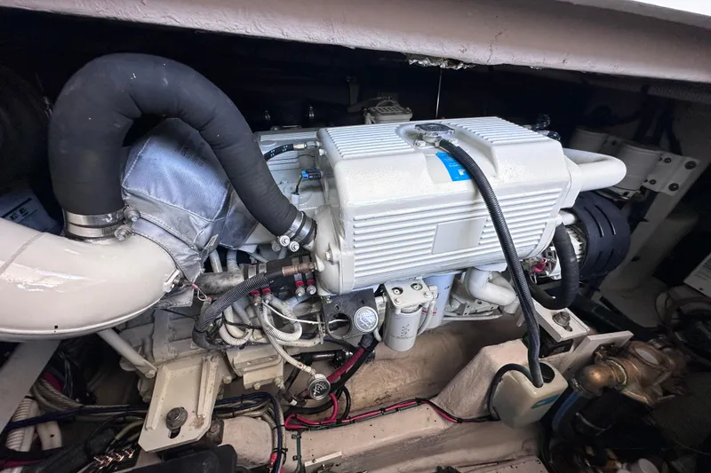 Slide: The Image of 2005 Sea Ray 48 Sundancer interior with kitchen, dining area, and cozy seating. - 33