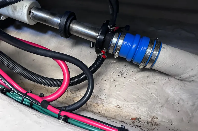 Slide: The Image of Engine compartment of 2005 Sea Ray 48 Sundancer with cables and hose connections. - 56