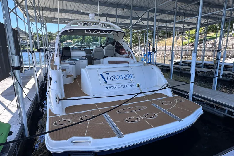 Slide: The Image of 2005 Sea Ray 48 Sundancer docked, rear view, with "Vincitore" and "Port of Liberty, MO" displayed. - 59