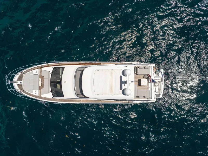 Slide: The Image of Aerial view of 2022 Azimut Fly 60 yacht on shimmering blue water. - 10