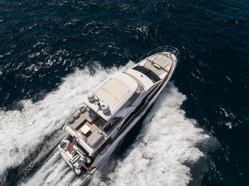 Slide: The Image of Aerial view of 2022 Azimut Fly 60 yacht cruising on open water. - 11