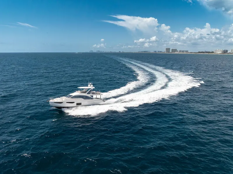 Slide: The Image of 2022 Azimut Fly 60 yacht cruising on open ocean under clear blue sky. - 14