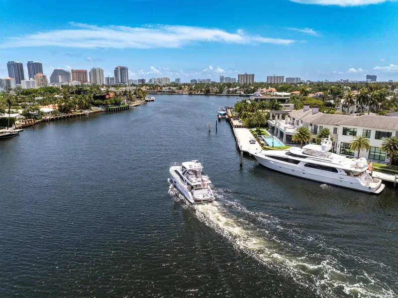 Slide: The Image of Azimut Fly 60 yacht cruising in a scenic waterfront cityscape, 2022 model. - 18