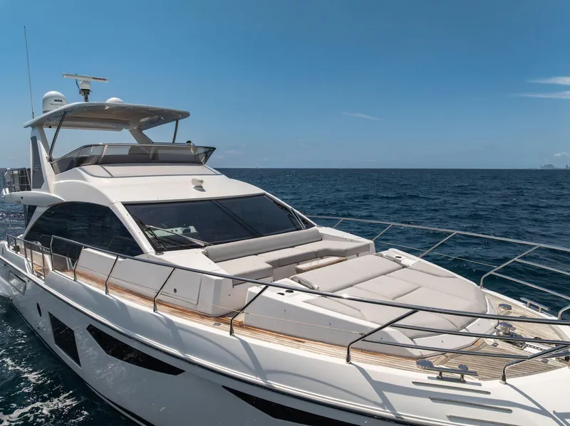 Slide: The Image of 2022 Azimut Fly 60 yacht cruising on open sea under clear blue sky. - 19