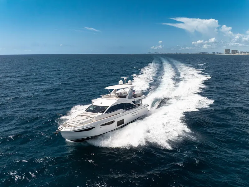 Slide: The Image of Azimut Fly 60 yacht cruising on open sea, 2022 model, under clear blue sky. - 2